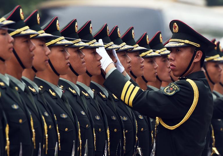 Binh lính Trung Quốc chỉnh lại lễ phục bên ngoài Đại lễ đường Nhân dân ở Bắc Kinh trước buổi lễ tiếp đón Thủ tướng Đức Angela Merkel
