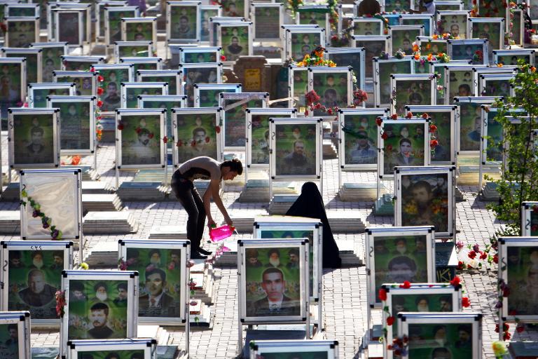 2 người dân Iraq đang dọn dẹp cho ngôi mộ của người thân tại một trong những nghĩa trang lớn nhất thế giới ở thành phố Najaf, Iraq