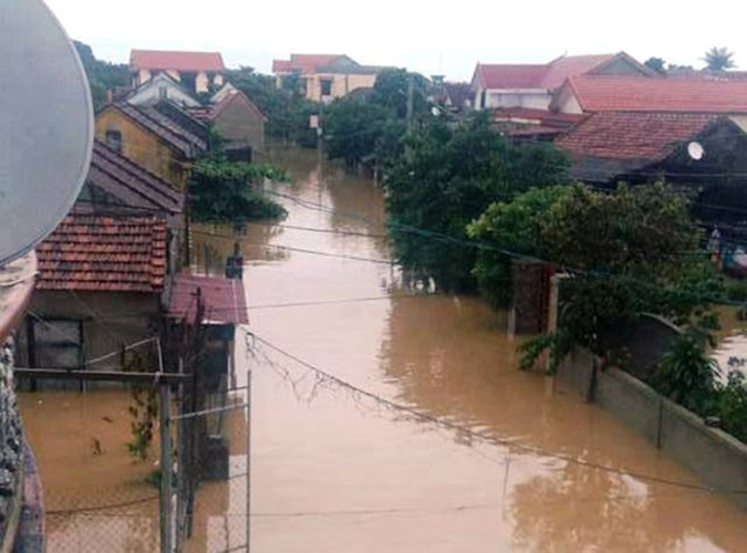 Các nhà dân ở huyện Lệ Thủy, Quảng Bình chơi vơi giữa dòng nước lụt. Ảnh: VTC News