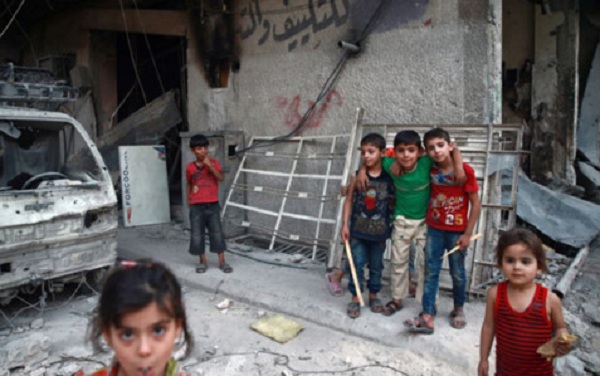 Những đứa trẻ chơi đùa trên đường phố hoang tàn ở Ghouta, Syria. Ảnh: Reuters.