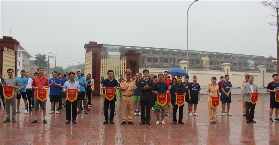 Đại tá Cao Minh Phượng, Trưởng phòng CSGT đường bộ - đường sắt và Thượng úy Nguyễn Đình Khánh, Phó bí thư Đoàn TN Công an tỉnh trao cờ lưu niệm cho các đội thi đấu